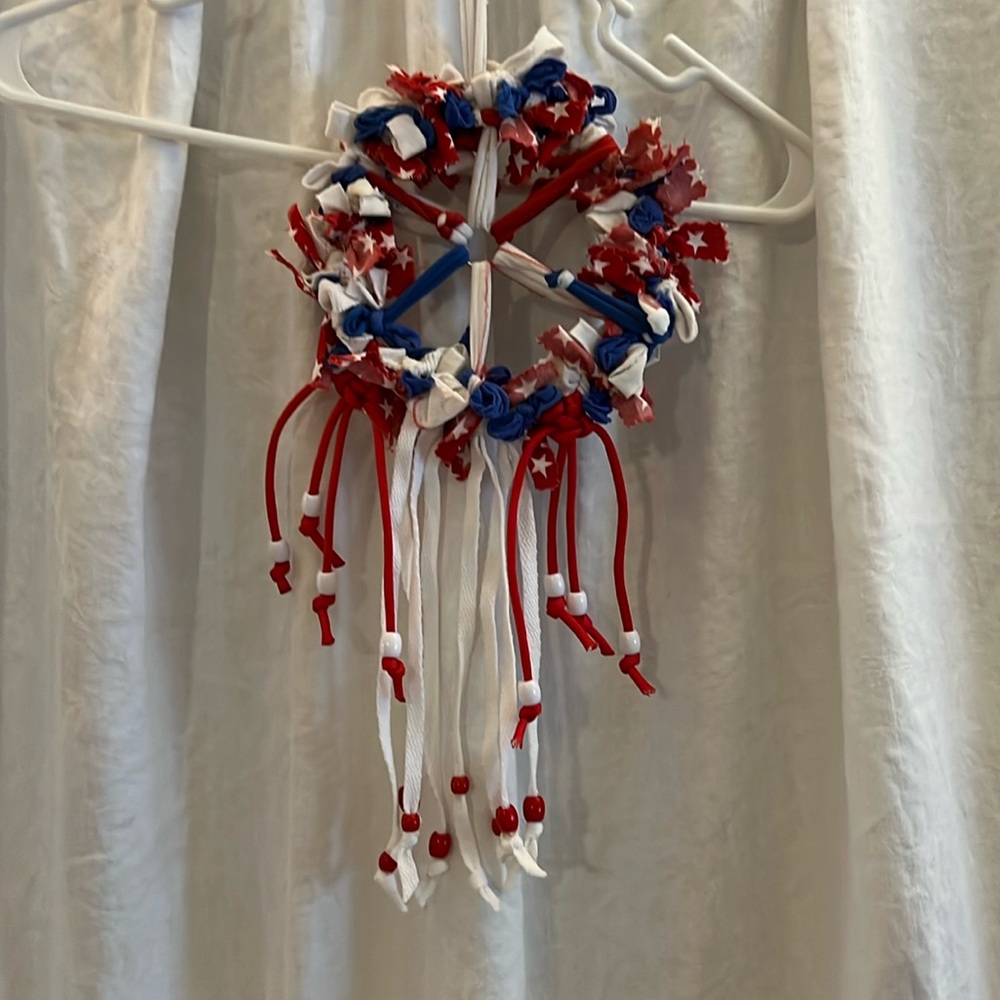 Dream catcher made from nylon loops, cotton strips on metal hoop